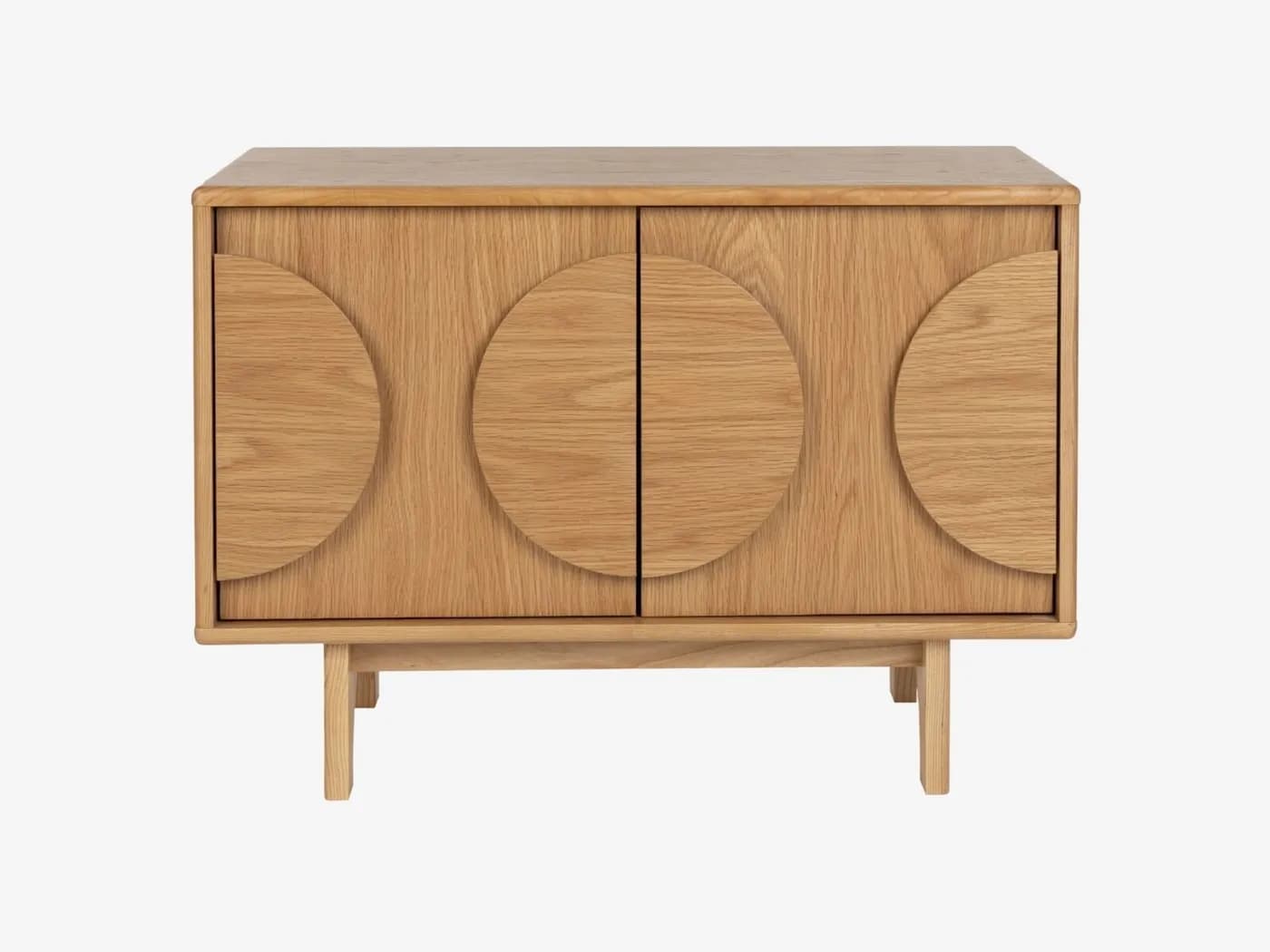 A modern storage cabinet constructed from light-colored oak wood, featuring two doors with distinctive semi-circular carved handles that form a full circle when the doors are closed. The cabinet stands on four splayed, tapered legs. The design is clean and minimalist, highlighting the natural wood grain. — 3D model