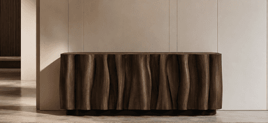A contemporary sideboard featuring a distinctive wavy, undulating facade crafted from dark-stained wood, likely walnut. The top surface has softly rounded edges, complementing the organic flow of the front panels. The unit is supported by a recessed, minimalist black base, giving it a floating appearance. The absence of visible handles suggests a push-to-open or similar mechanism for its storage compartments. — 3D model
