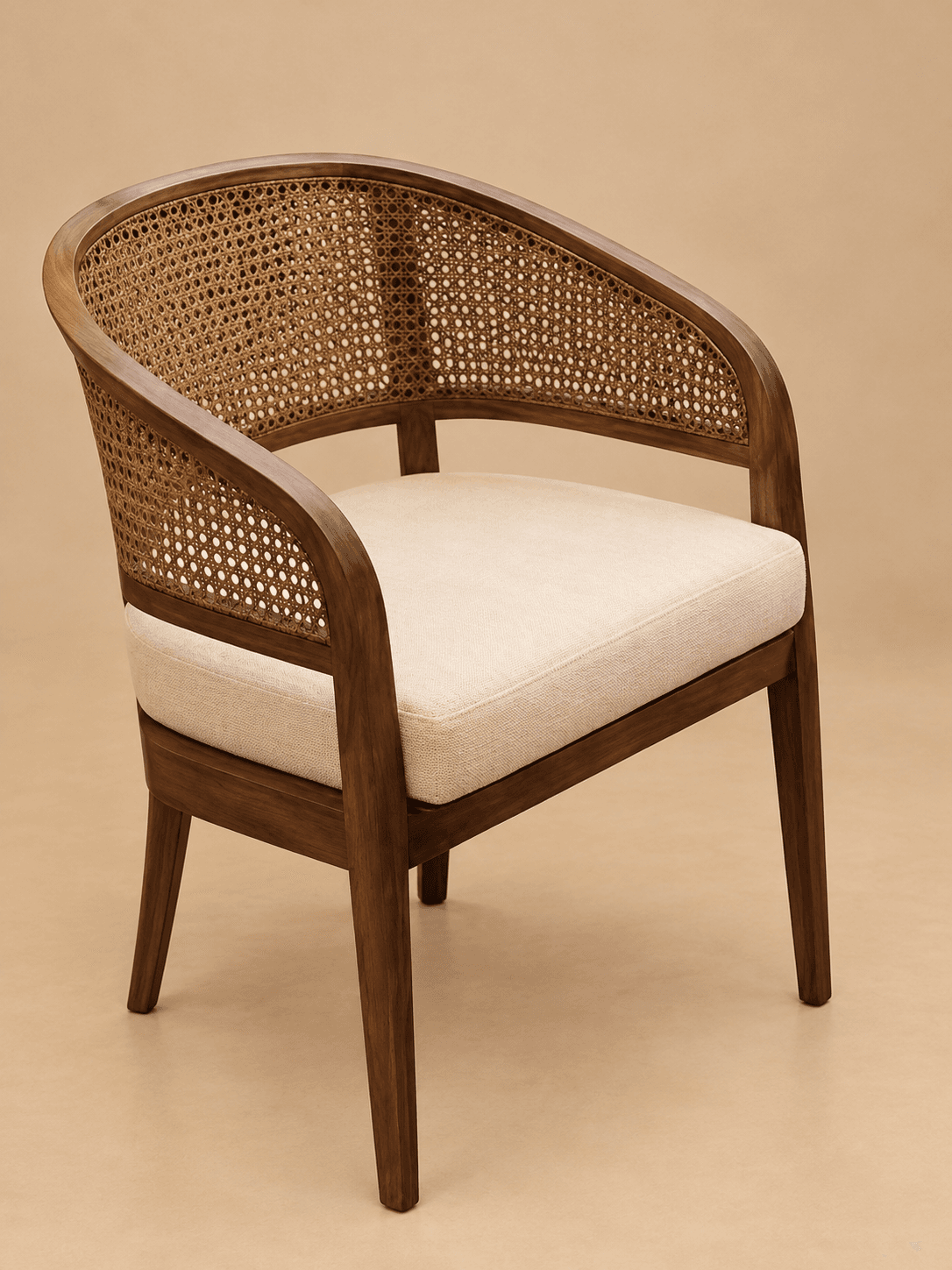 A contemporary armchair featuring a solid wood frame with a curved barrel-style back and arms, incorporating a woven cane panel in the backrest. The seat is upholstered with a light-colored fabric cushion. — 3D model
