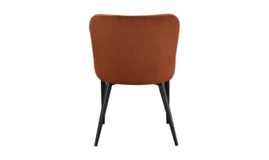 A side chair with a padded backrest and seat, upholstered in a rust-colored velvet fabric. The chair features a gently curved, slightly winged back and four slender, tapered black metal legs. The design is minimalist and modern. — 3D model
