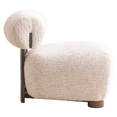 This lounge chair features a low-profile, rounded silhouette upholstered in a textured bouclé fabric. The seat and backrest are generously padded for comfort, with the backrest curving slightly to embrace the user. A dark wood frame is visible behind the upholstered backrest, providing structural support and a visual contrast to the soft upholstery. The chair rests on four short, cylindrical wooden legs, further emphasizing its grounded and sculptural form. — 3D model
