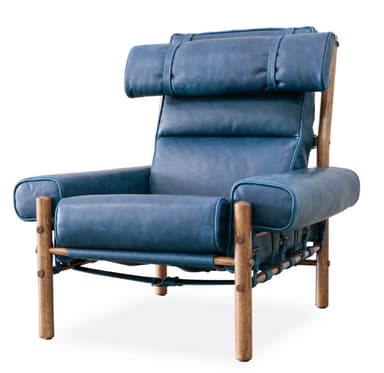 A high-backed armchair with a distinct, padded headrest secured by leather straps. The seat and back cushions are segmented, creating a tufted appearance. The frame is constructed from natural wood posts, with visible metal fasteners and leather strapping supporting the seat. — 3D model