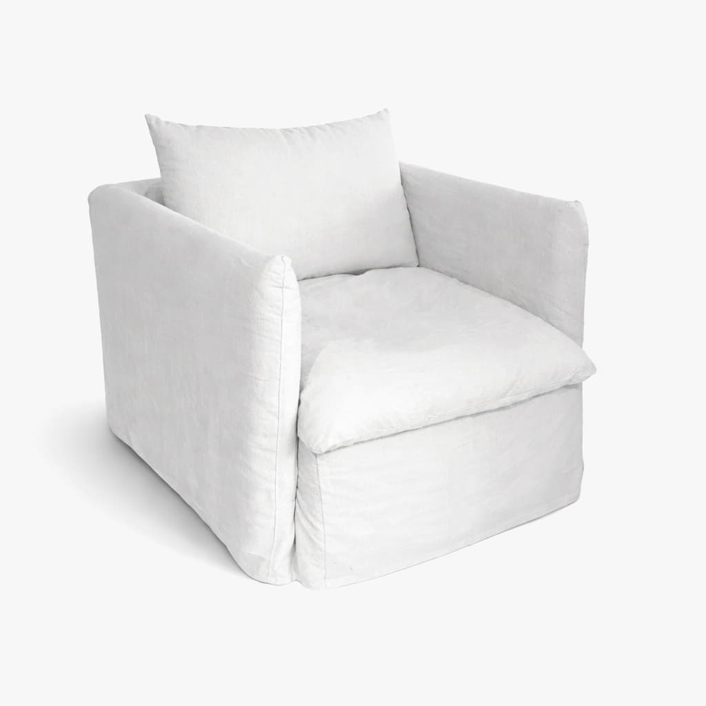 A white slipcovered armchair with a square silhouette. It features a single seat cushion and a back cushion, with generously sized armrests. The slipcover extends to the floor, creating a skirted base. The overall design appears casual and comfortable. — 3D model