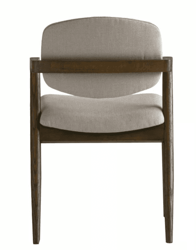 A modern armchair with a wooden frame and upholstered seat and backrest. The chair features a curved, segmented backrest and a slightly contoured seat, both covered in a textured, light-colored fabric. The armrests are integrated into the wooden frame, which has a natural, dark wood finish with visible grain patterns. The legs are slender and angled outwards. — 3D model