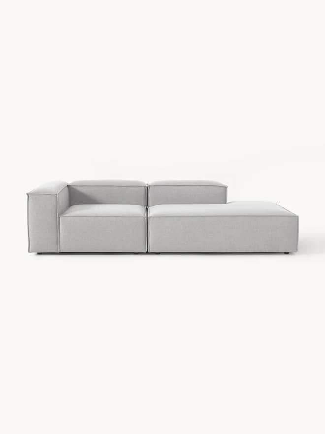 A modular sofa composed of two distinct sections placed side-by-side. The left section is an armless corner piece with a backrest. The right section is an armless seat with an integrated chaise lounge extension. Both sections have clean lines and a minimalist aesthetic. — 3D model