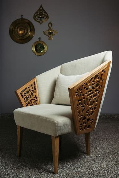 A modern armchair featuring a high, angular backrest and a cushioned seat and back. The armchair has distinctive wooden armrests with intricate geometric cutouts. The legs are tapered and made of wood. — 3D model