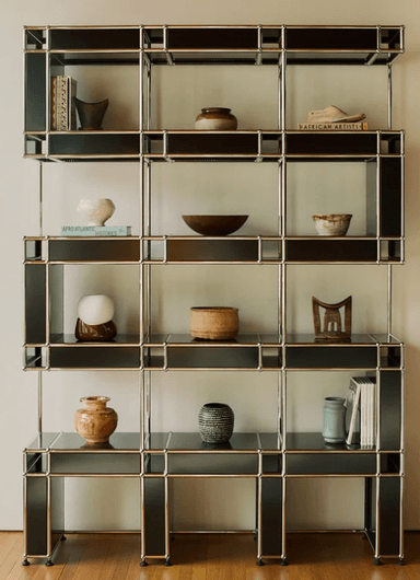 A tall, multi-level modular shelving and storage unit featuring a silver metal framework and black laminate panels, forming various open and semi-enclosed compartments. — 3D model