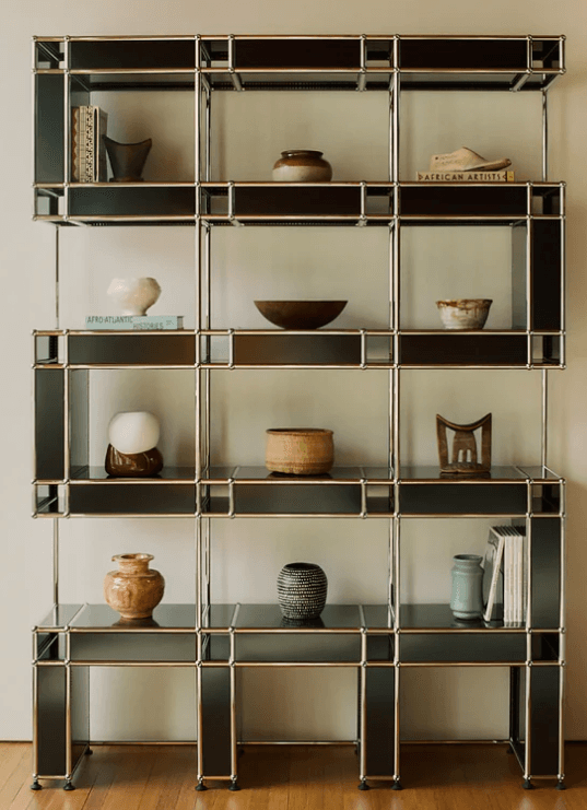 A tall, multi-level modular shelving and storage unit featuring a silver metal framework and black laminate panels, forming various open and semi-enclosed compartments. — 3D model