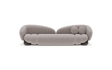 A contemporary, generously sized sofa with an organic, bulbous form. It features a low profile with rounded arms that curve inward, and a plush, textured upholstery. The seat and backrest are segmented, creating a unique visual texture. Two spherical throw pillows are integrated into the design, resting on the backrest. — 3D model