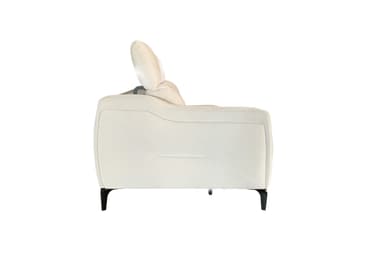 A modern, light-colored sofa with two attached seat cushions and a sleek, low-profile design. The sofa features a button-tufted pattern on the seat base, creating a geometric segmented appearance. It is elevated by thin, dark-colored legs, giving it a floating effect. The backrest is a continuous, softly padded surface. — 3D model