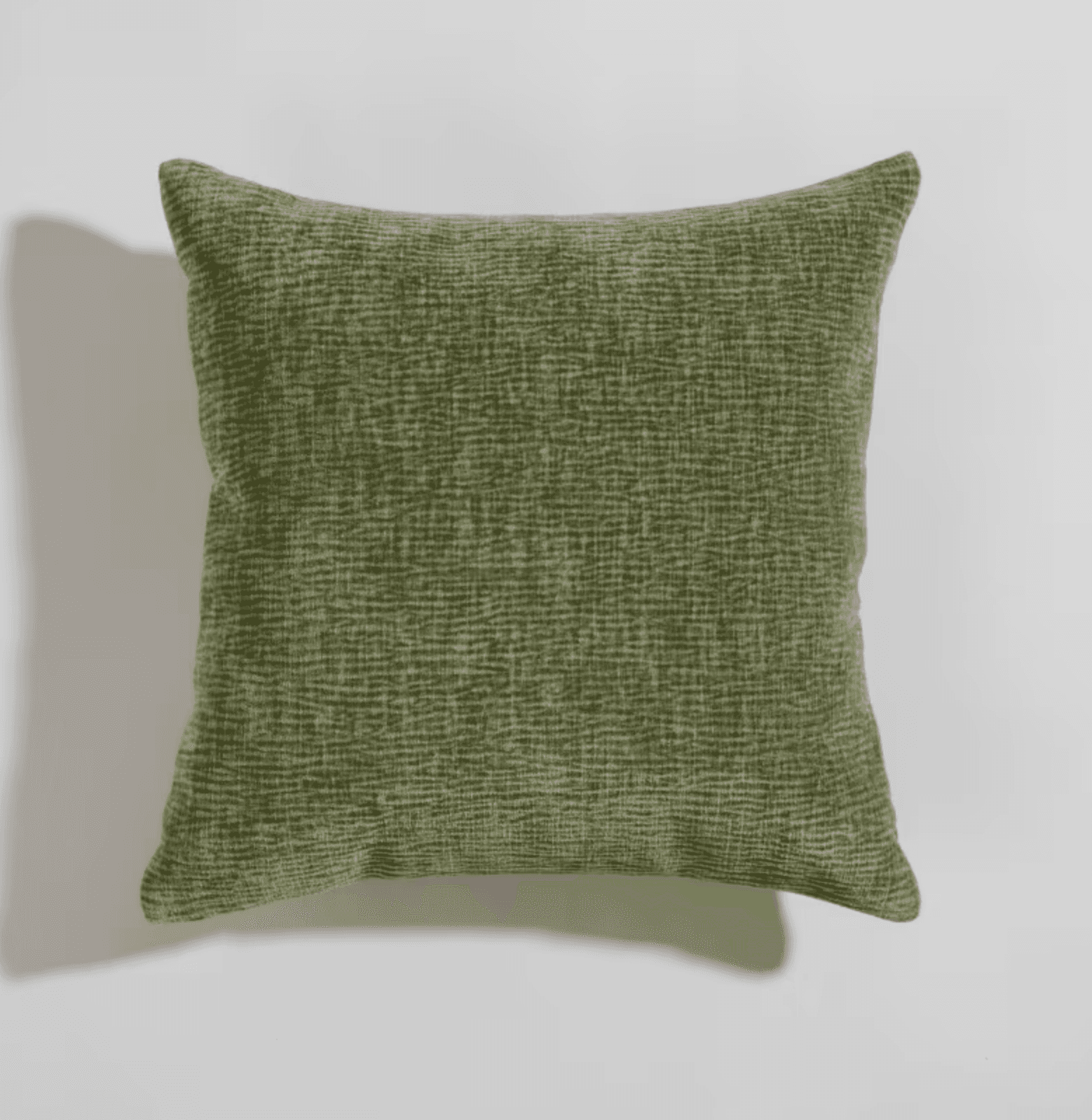 A square-shaped cushion with a textured green fabric cover. The texture appears to be a woven pattern with subtle variations in shade, creating a naturalistic or abstract effect. The cushion is slightly plump, suggesting it is filled with soft material. It is shown against a plain, light-colored background, with a shadow cast to its left. — 3D model