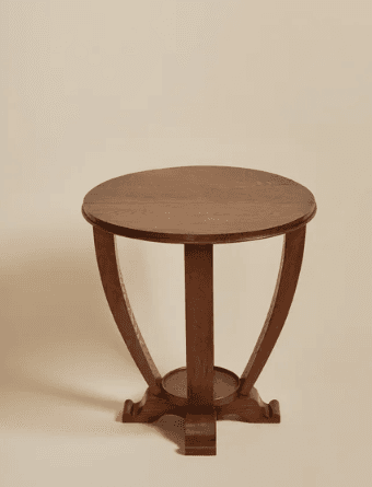 A round-topped wooden side table with a distinctive base featuring four curved legs that taper upwards to support the tabletop. A circular shelf is positioned midway down the legs. The wood exhibits a visible grain pattern. — 3D model