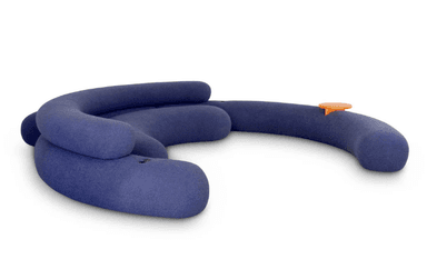 A modular sofa with a curved, organic design. It appears to be upholstered in a soft, textured fabric and features plump, rounded sections that form a seating area. There is a small, circular orange accessory attached to one of the sections, possibly a control or decorative element. The overall form is playful and contemporary. — 3D model