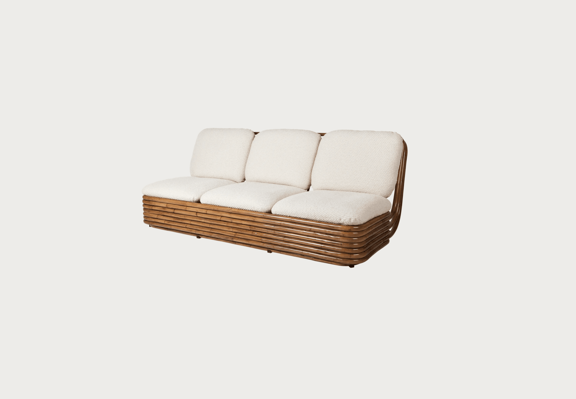 A three-seater sofa featuring a distinctive bent bamboo and rattan frame, complemented by three individual off-white bouclé seat and back cushions. The frame exhibits curved edges and a slatted base structure made from multiple parallel bamboo stalks. The cushions are upholstered in a textured, light-colored fabric, providing a soft contrast to the natural wood tones of the frame. The sofa sits low to the ground on small, discreet feet. — 3D model