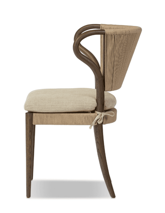 A modern armchair with a curved wooden frame and a woven backrest. The seat is upholstered with a neutral-colored fabric. The armrests are also formed from curved wooden elements, seamlessly integrating into the backrest structure. The woven back features vertical cords creating a textured surface. A tie closure secures the seat cushion. — 3D model