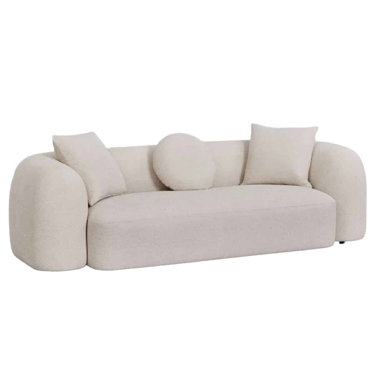 A modern, minimalist sofa featuring a low-profile design and soft, rounded armrests. It is upholstered in a textured, light-colored boucle-like fabric and includes three matching throw pillows: two square and one round. — 3D model