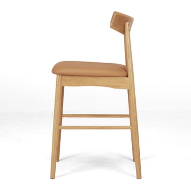 A modern bar stool featuring a light oak wood frame, a gently curved backrest, and a tan leatherette padded seat. It is designed with integrated footrests and straight, round tapered legs. — 3D model