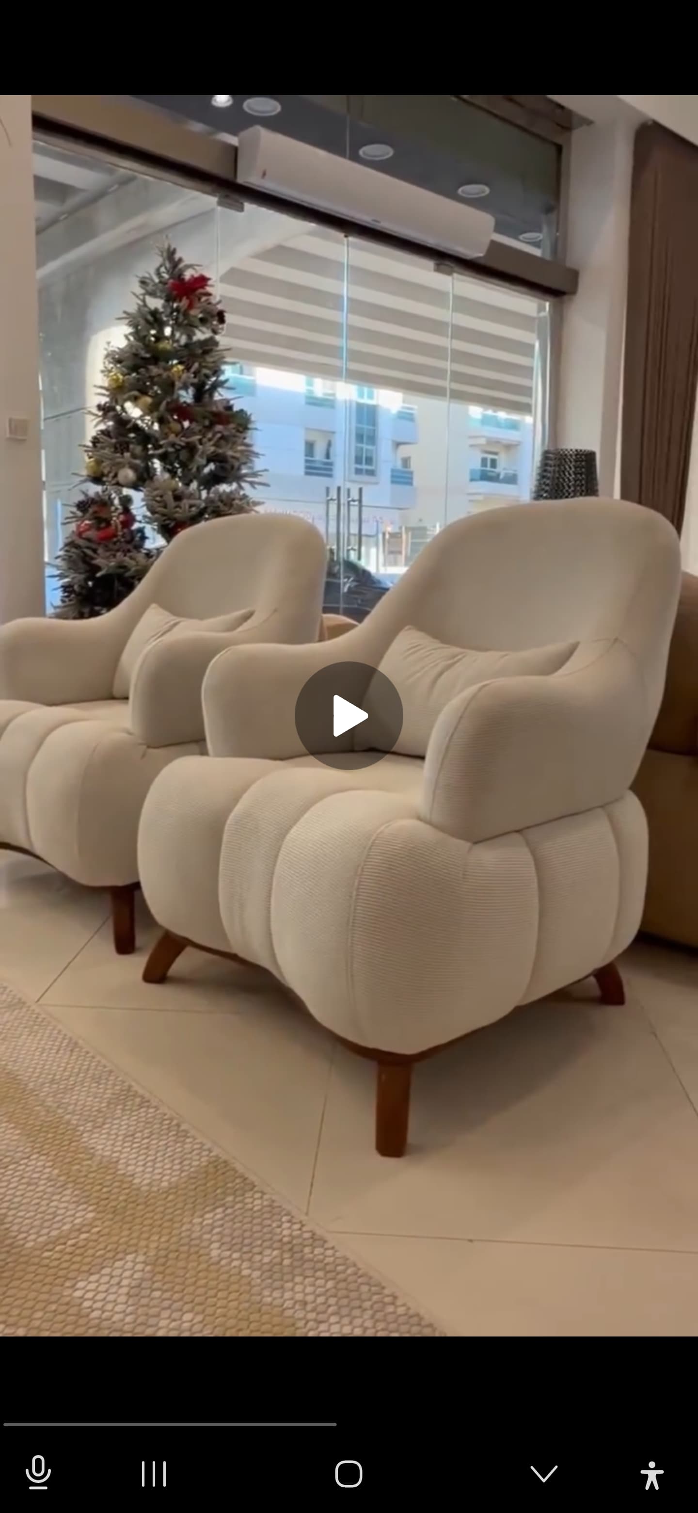 A modern, plush accent armchair with a rounded silhouette, upholstered in a textured, off-white boucle-like fabric featuring distinct channel tufting on the backrest and seat. It stands on four short, tapered wooden legs. — 3D model