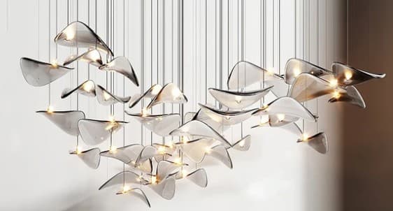 A large, contemporary lighting fixture featuring numerous individual translucent elements suspended by thin cables. Each element, shaped like an organic leaf or petal, houses a light source, creating a luminous, cloud-like composition. The fixture has a sculptural and ethereal quality, suggesting a modern design aesthetic. — 3D model