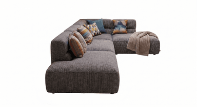 A contemporary modular L-shaped sectional sofa upholstered in a textured grey fabric. It features deep seats, integrated low armrests, and is accessorized with several colorful, patterned throw pillows and a chunky knit blanket. — 3D model