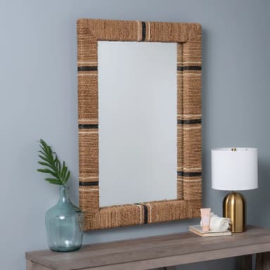 A rectangular mirror with a thick frame wrapped in natural fiber rope. The rope has alternating bands of black and white. The mirror is designed to be wall-mounted and reflects the surrounding environment. — 3D model