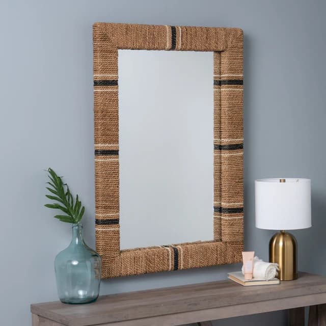 A rectangular mirror with a thick frame wrapped in natural fiber rope. The rope has alternating bands of black and white. The mirror is designed to be wall-mounted and reflects the surrounding environment. — 3D model