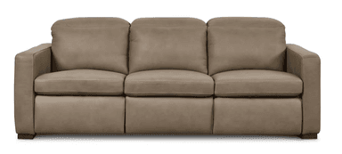 A three-seater sofa with a neutral taupe upholstery, featuring plush, overstuffed cushions on the back and seat. The arms are padded and squared, with visible stitching details along the edges and seams. The base of the sofa is solid and rests on short, dark rectangular feet. — 3D model
