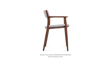 A side profile view of a modern armchair with a wooden frame and upholstered seat and backrest. The frame is constructed from solid ash with a walnut finish. The upholstery appears to be a light grey nubuck fabric. — 3D model