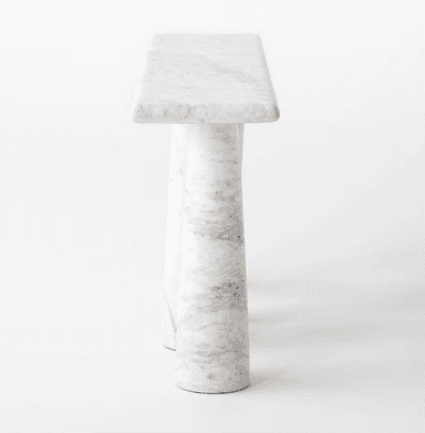 A minimalist and sculptural console table crafted entirely from white marble with subtle grey veining. The table features a rectangular top supported by a uniquely designed base consisting of organically curved or twisted marble pillars, giving it a solid and artistic appearance. The surfaces are polished, enhancing the natural beauty of the stone. — 3D model
