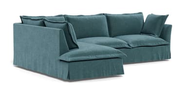 An L-shaped sectional sofa upholstered in a teal fabric, featuring deep seats and a casual, contemporary design. The sofa includes multiple loose back cushions and a wide chaise extension on the left side (when viewed from the front). It has a skirted base, suggesting a relaxed aesthetic. — 3D model