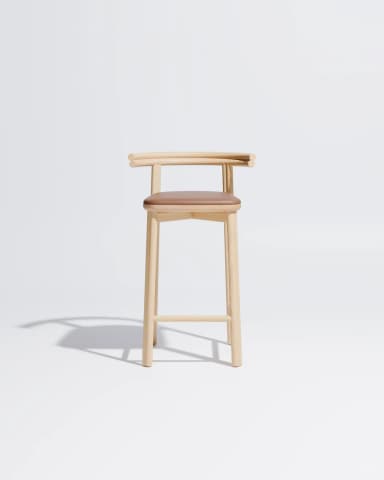 A minimalist bar stool constructed from light-toned oak wood featuring a subtly curved backrest that seamlessly transitions into the side supports. The frame consists of four slender, gently splayed legs connected by horizontal stretchers serving as footrests. A padded seat upholstered in brown leather provides contrast and comfort. The overall design emphasizes clean lines and natural materials, characteristic of Scandinavian or modern minimalist aesthetics. — 3D model