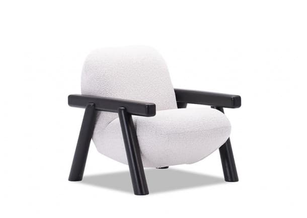 A contemporary lounge chair featuring a plush, light-colored bouclé upholstery and a contrasting exposed black wooden frame. The chair has a rounded, inviting silhouette with thick cushions for both the seat and backrest. Its armrests are wide and rectangular, supported by sturdy, slanted black wooden legs that give it a modern and minimalist aesthetic. — 3D model