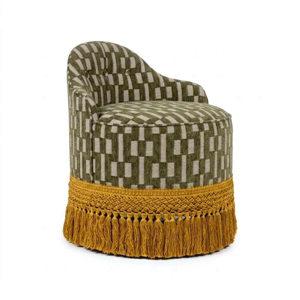 A compact, fully upholstered barrel-shaped chair featuring a low, rounded backrest that seamlessly merges into the seat. The chair is covered in a woven fabric with a geometric pattern in olive green and light beige/grey. Its base is adorned with a prominent mustard yellow braided trim and a voluminous tassel fringe. — 3D model