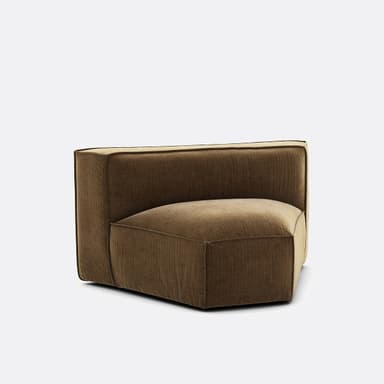 A modular armchair with a low profile and a geometric design. The upholstery features a corduroy-like texture with vertical ribbing. The seat is a rounded pentagonal shape, and the backrest is straight and slightly curved to form a corner unit. The frame appears to be upholstered, with visible piping along the seams. — 3D model