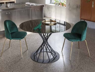 A round dining table with a dark, marbled top and a sculptural metal base. The base consists of thin, vertical metal rods twisted into a helix shape, supported by a flat circular base. — 3D model