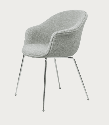 A modern upholstered chair with integrated armrests and slender chrome legs, viewed from a rear-side angle against a plain background. — 3D model