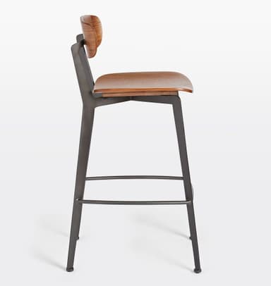 A bar stool with a backrest, featuring a wooden seat and back panel, supported by a dark metal frame. The seat and back panel appear to be made of bent wood or plywood with a wood grain finish. The frame consists of angled legs connected by a footrest at the bottom and supports for the seat and back. The design is modern and minimalist. — 3D model