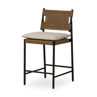 A contemporary bar stool featuring a dark-colored metal frame, a woven synthetic rattan seat and backrest, and a light-colored fabric cushion. The stool includes an integrated footrest for comfort. The backrest has cut-out handles on either side, and the overall aesthetic is clean and modern, suggesting suitability for both indoor and outdoor environments. — 3D model