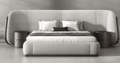 A modern upholstered platform bed featuring a light grey fabric frame and an expansive, curvilinear headboard. The headboard extends outwards and curves down on both sides, incorporating two round, dark brown nightstands. The bed is dressed with white bedding and a brown throw. — 3D model