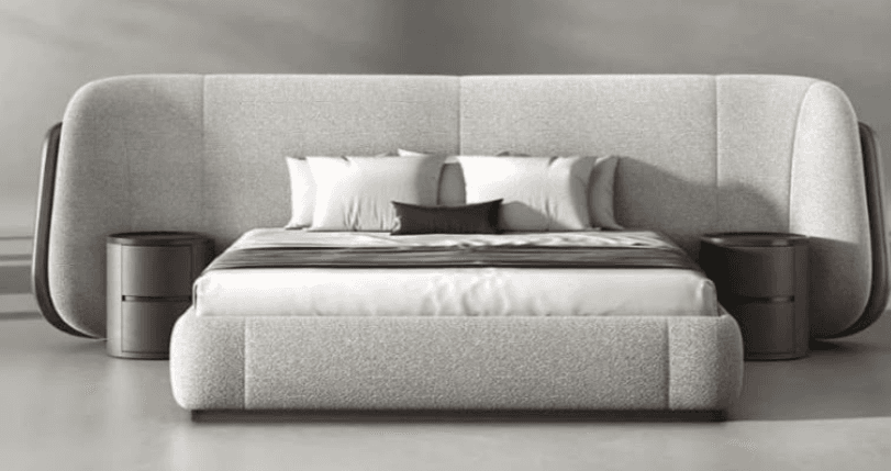 A modern upholstered platform bed featuring a light grey fabric frame and an expansive, curvilinear headboard. The headboard extends outwards and curves down on both sides, incorporating two round, dark brown nightstands. The bed is dressed with white bedding and a brown throw. — 3D model