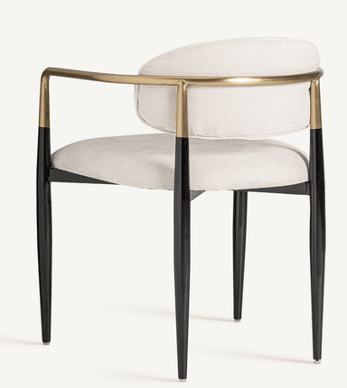 A modern armchair with a gently curved back and seat, upholstered in a textured light-colored fabric. The chair features sleek, tapered legs in black, and its armrests are formed by a continuous metal tube with a brass finish, attached to the frame. — 3D model