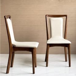 A contemporary dining chair featuring a rich, dark walnut-stained wooden frame and a light cream-colored upholstered seat and backrest. The backrest forms a distinctive U-shaped element that seamlessly integrates into the rear legs, creating a sleek silhouette. The front and rear legs are slender and slightly tapered. — 3D model