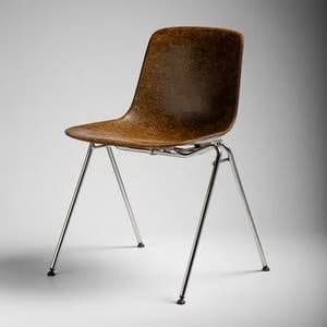A Mid-Century Modern armless side chair featuring a single-piece, ergonomically shaped molded plywood shell in a rich brown finish, supported by a minimalist four-leg base made of slender chrome-plated steel. The chair exhibits a sleek, functional design characteristic of the era, with visible wood grain texture on the seat shell. — 3D model