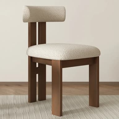 A modern dining chair featuring a solid wooden frame with block legs and a distinctive cylindrical bolster backrest. Both the seat and backrest are upholstered in a textured, off-white bouclé fabric, providing a soft contrast to the dark brown wood. The design is minimalist, emphasizing clean lines and robust construction. — 3D model