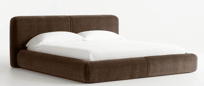 A contemporary upholstered bed frame with a low profile and a two-panel headboard. The frame and headboard are covered in a dark brown, textured fabric. The bed is shown with white bedding. — 3D model