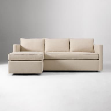 A contemporary sectional sofa upholstered in a light beige woven fabric, featuring a right-hand facing chaise lounge, low square arms, and loose back and seat cushions with tailored piping. — 3D model