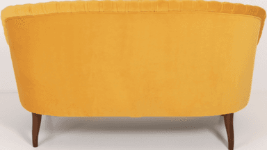 A traditional style armchair upholstered in a rich yellow velvet fabric. The chair features distinct rolled arms and a rolled crest rail on the backrest. It has four wooden legs, with a visibly turned leg at the front and a tapered leg at the rear. — 3D model