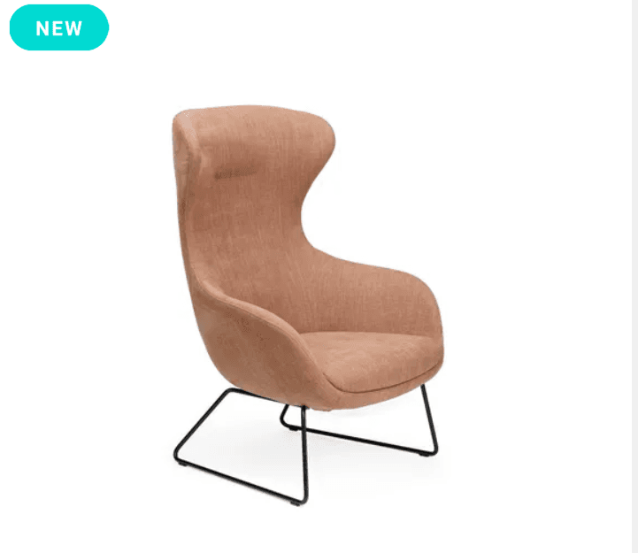 A contemporary high-back lounge chair with a minimalist design, featuring a fully upholstered seat and back in a light peach/terracotta woven fabric. The chair's enveloping form includes subtle integrated armrests, and it is supported by a slender, black powder-coated metal sled base. — 3D model
