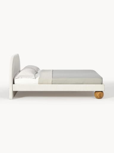 An upholstered bed frame featuring a gently arched headboard and distinctive spherical wooden feet, presented with neutral bedding. — 3D model