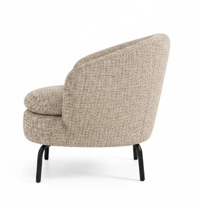 A modern, compact tub chair featuring a rounded, continuous back and integrated armrests, upholstered in a textured, neutral-toned fabric, supported by slender, tapered black metal legs. — 3D model